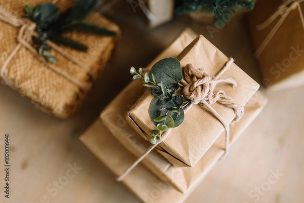 Fototapeta Gift boxes in a natural style: minimalist packaging made of kraft paper and decorative details from natural materials