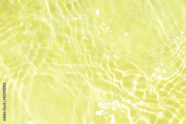 Fototapeta Blue water with ripples on the surface. Defocus blurred transparent blue colored clear calm water surface texture with splashes and bubbles. Water waves with shining pattern texture background.