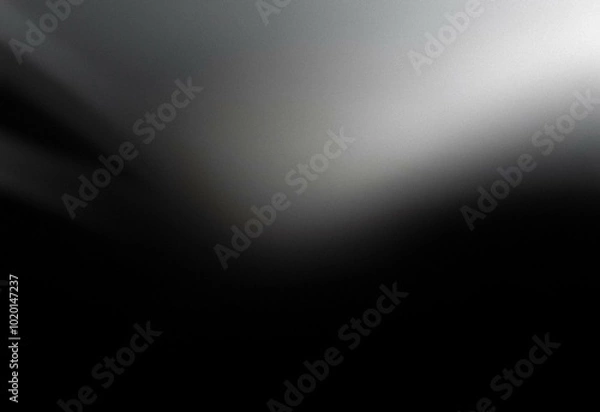 Fototapeta A grainy, abstract black and white gradient background.