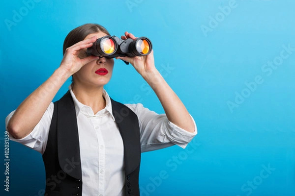 Obraz Business woman with a binoculars