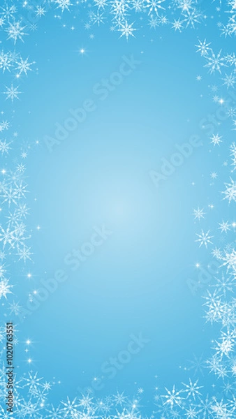 Fototapeta snow flakes frame on blue sky background,white snow flakes flying ,happy new year and merry Christmas holiday vertical social media design element ,winter snowy sky