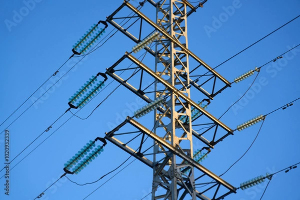 Fototapeta High voltage towers aganist the blue sky background. High quality photo