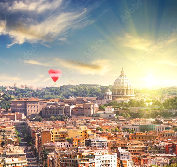 Fototapeta Aerial View of St. Peter's cathedral in Rome, Italy at sunset with red balloon in form of heart. Counter light shot. Business, Love and travel concept