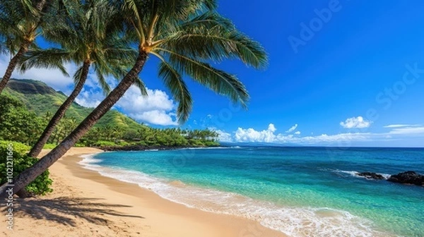 Obraz Tropical beach paradise with palm trees, golden sand, and clear blue water under a vibrant sky.