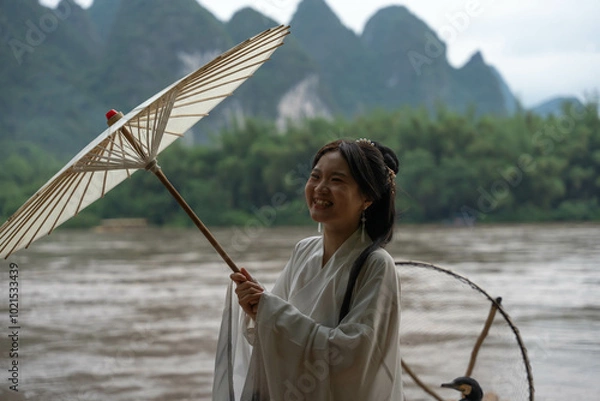 Obraz Happy Hanfu Woman smiles and thumbs up by Li River. China, 4K