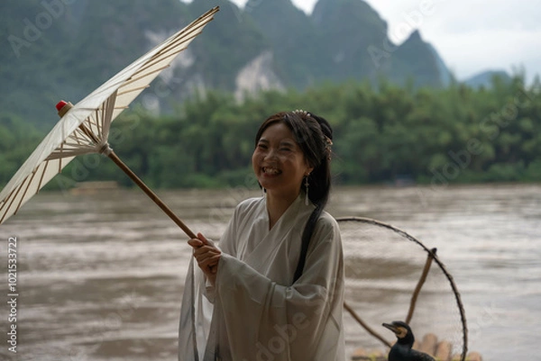 Obraz Happy Hanfu Woman smiles and thumbs up by Li River. China, 4K