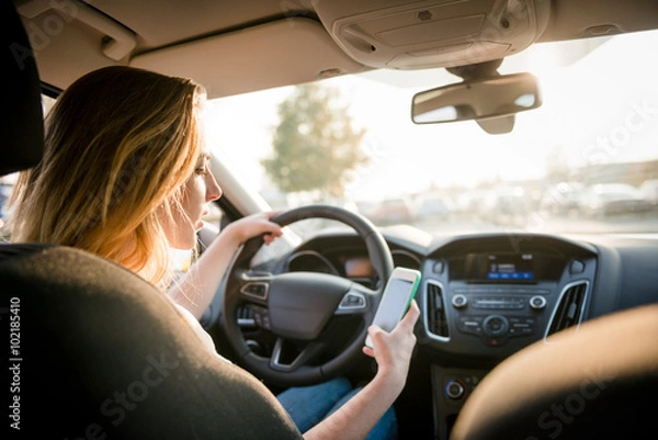 Fototapeta Using phone while driving