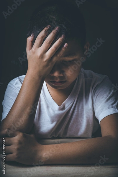 Fototapeta scared and alone, young Asian child who is at high risk of being bullied, trafficked and abused