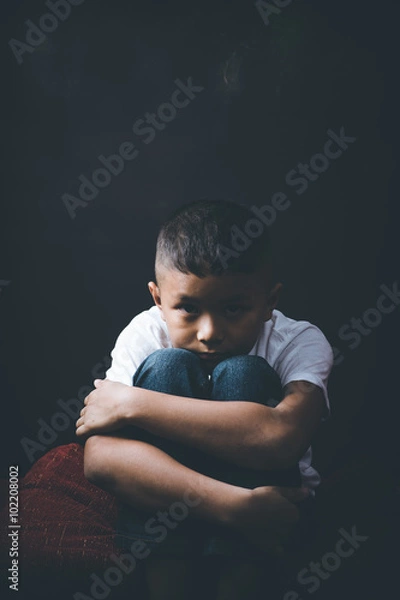 Fototapeta scared and alone, young Asian child who is at high risk of being bullied, trafficked and abused