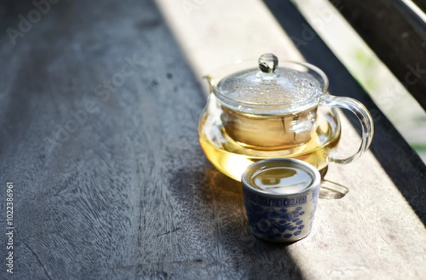 Fototapeta Chamomile tea in a clear teapot.