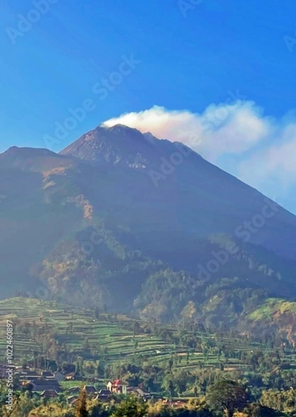 Obraz view of mount merapi with green valley and a house below