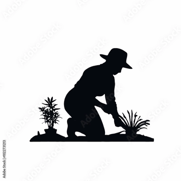 Obraz A silhouette of a farmer or gardener working in a field or garden