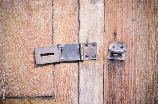 Obraz Close up of old door bolt on wooden background 
