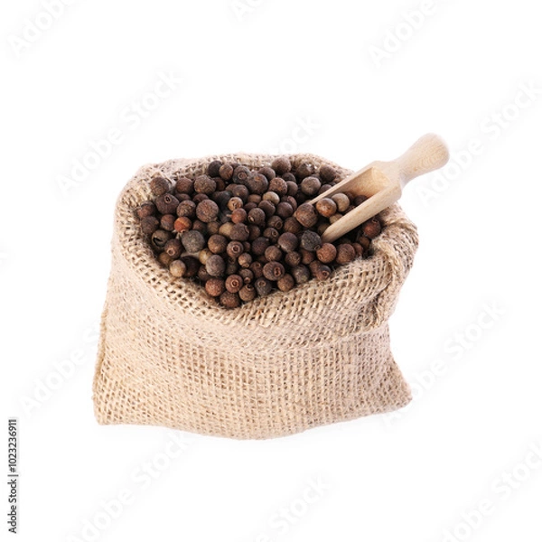 Fototapeta Burlap sack with allspice and scoop isolated on white
