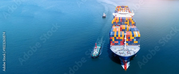 Obraz Front view of Cargo container ship carrying container and running out international container port customs shipyard sea port concept smart logistic service..