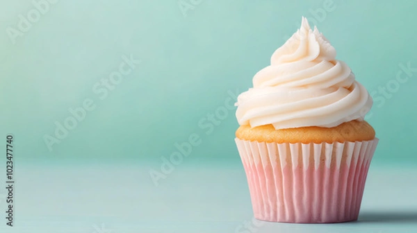 Fototapeta Delicious cupcake with creamy frosting on a pastel background, perfect for dessert lovers and baking enthusiasts.