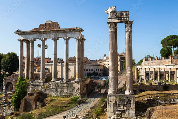 Fototapeta View of the ruins of the Roman Forum with the temple of Saturn and the temple of Vespasian and Titus. Rome, Italy