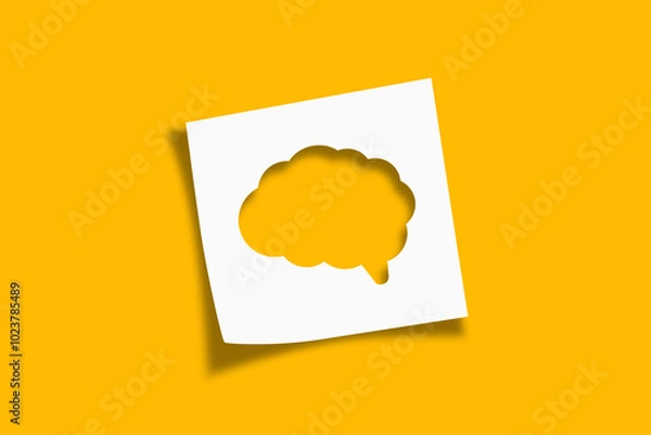 Fototapeta Mental health and problems with memory. Human brain shaped cut out on white note paper on yellow background.