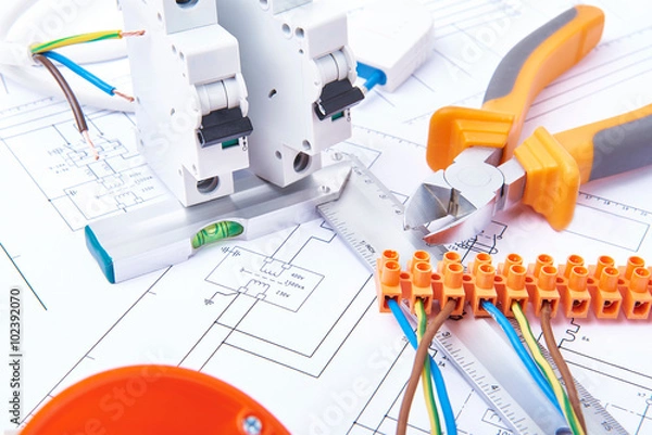 Fototapeta Components for use in electrical installations. Cut pliers, connectors, fuses and wires. Accessories for engineering work, energy concept.