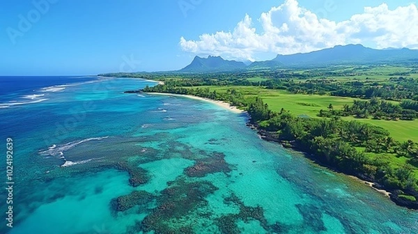 Fototapeta Aerial view of a pristine coastline with clear turquoise water.