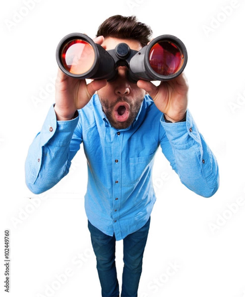 Obraz young man using binoculars