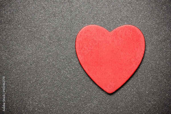 Obraz Red wooden heart on black surface. Empty copy space background.