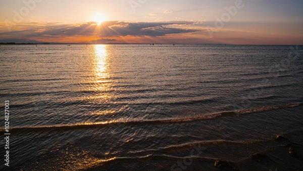 Fototapeta Cloudy sunset. View from the coast towards sea. Italy.