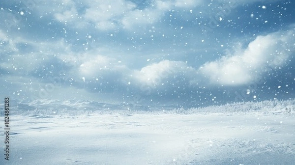 Fototapeta Winter storm approaching a snow-covered landscape with large blank space in the sky for copy