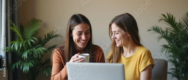 Obraz Friends Sharing a Laugh While Working on a Laptop