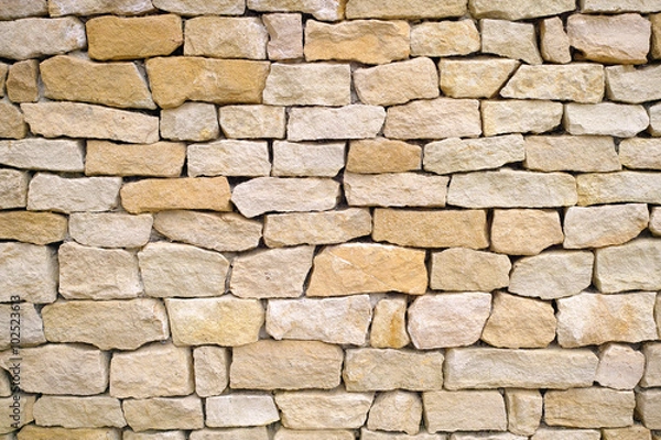 Fototapeta teksturowany mur z żółtej cegły wapiennej