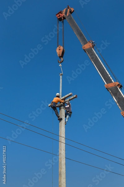 Fototapeta Electricians working in the height with crane .