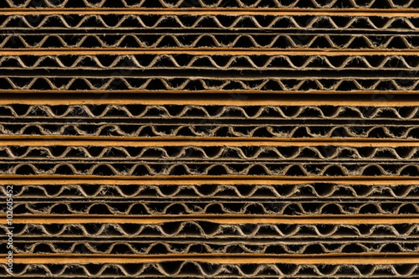 Fototapeta stack of corrugated cardboard boxes background. side perspective
