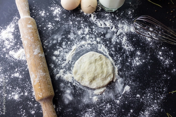 Fototapeta rolling dough with a rolling pin