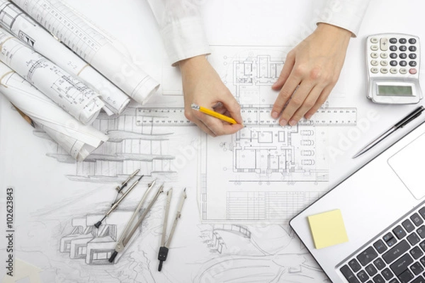 Fototapeta Architect working on blueprint. Architects workplace - architectural project, blueprints, ruler, calculator, laptop and divider compass. Construction concept. Engineering tools