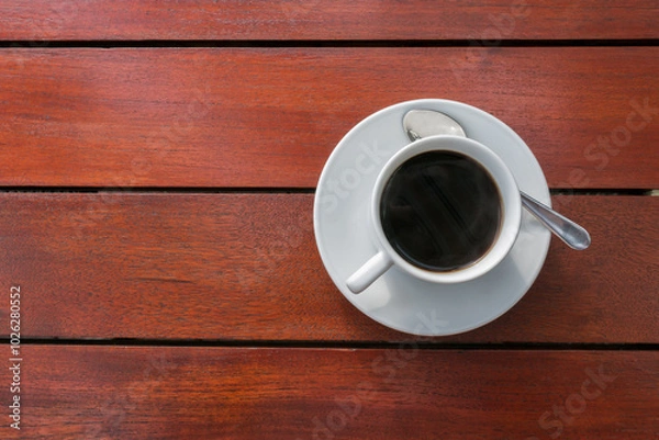 Fototapeta A cups of coffee on orange color wooden table background