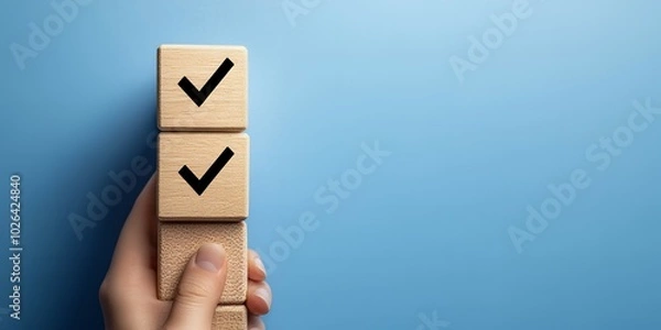 Fototapeta Hand holding wooden blocks with check marks