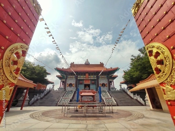 Fototapeta Wat Boromracha Kanchanapisek Anusorn or Wat Leng Noei Yi 2, A Chinese spiritual complex with brightly painted pagodas  shrines with golden seated Buddhas.