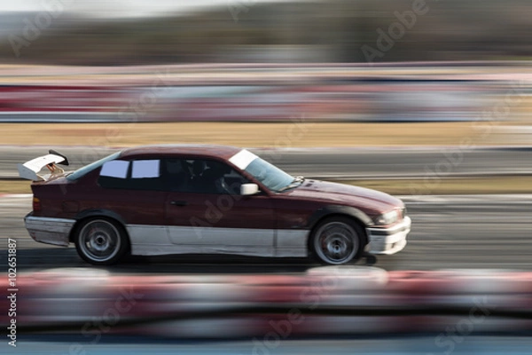 Fototapeta Car moving fast on the track