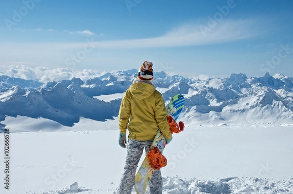 Obraz  Snowboarder, standing on the top of the mountain .