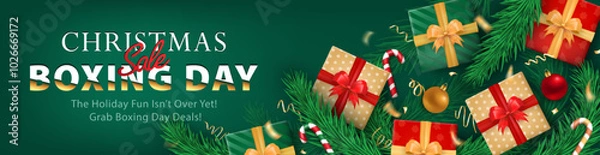 Fototapeta Christmas Boxing Day sale header, panoramic green banner with 3d gift boxes with ribbons, confetti, candy canes, baubles, and pine branches for promoting New Year, holiday deals, seasonal discounts