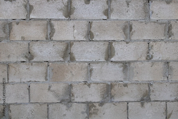 Fototapeta A cinder block wall texture with gray and white colors