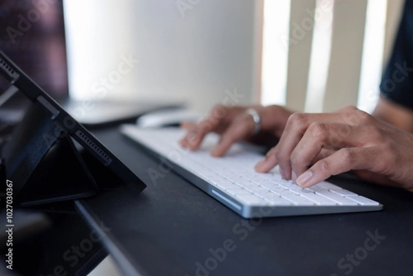 Fototapeta Concept of using technology in communication.Close-up A businessman working on his computer in the office.