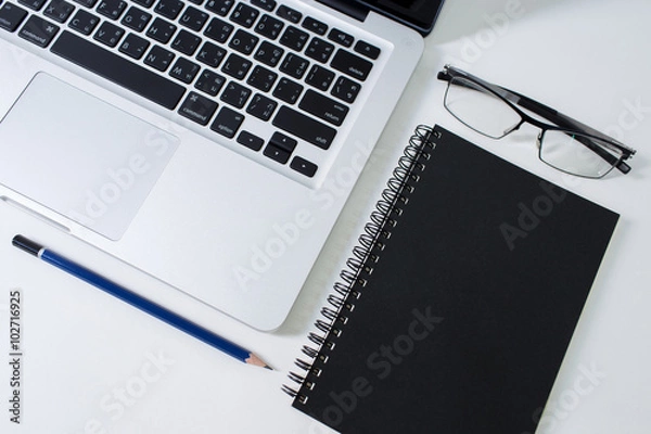Obraz Work desk with laptop, glasses, notebook and pencil
