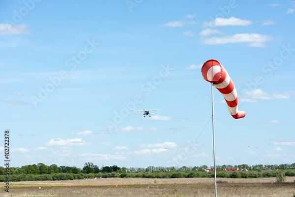 Obraz Windsock against cloudy sky.