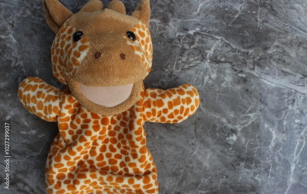 Obraz Cute Giraffe Puppet on Marble Background for Playful Fun