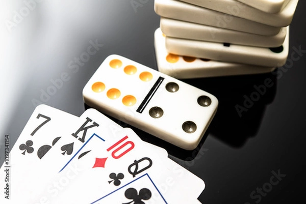 Fototapeta Playing Cards and Dominoes: A Close-Up Snapshot of Classic Gaming Elements for Family Fun and Gathering