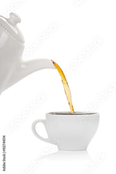 Fototapeta Pouring tea into a cup isolated on white