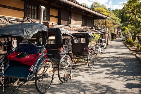 Obraz Row of Rickshaw parking next to traditional Japanese houses in Takayama, Japan