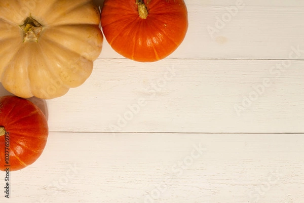 Fototapeta Halloween background with pumpkins. Flat lay. Frame with Halloween figures on white table, top view. Hallowen decorations for greeting and invitation. Happy Helloween concept. Holidays background