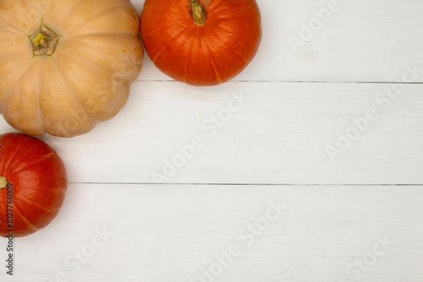Fototapeta Halloween background with pumpkins. Flat lay. Frame with Halloween figures on white table, top view. Hallowen decorations for greeting and invitation. Happy Helloween concept. Holidays background